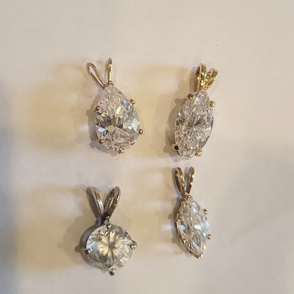 4 Diamond CZ pendants 2 diamond shapes, 1 pear shaped, and 1 round!